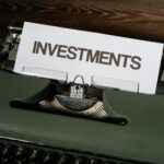 Close-up of a vintage typewriter with a paper labeled 'INVESTMENTS'.