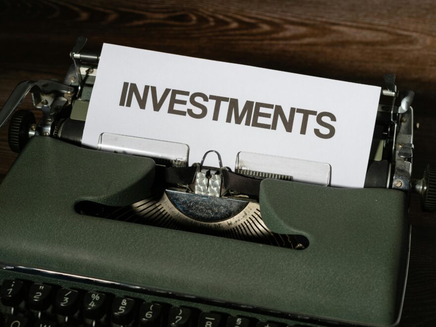 Close-up of a vintage typewriter with a paper labeled 'INVESTMENTS'.