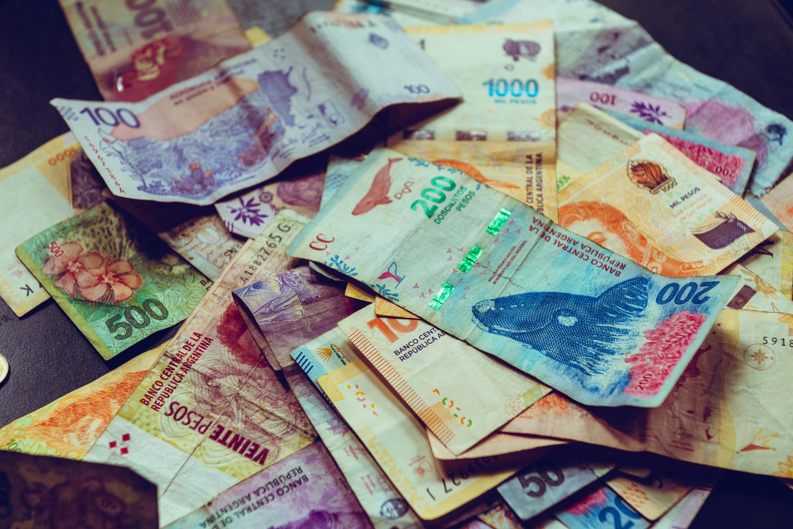 Vibrant assortment of Argentine Peso banknotes, showcasing various denominations and wildlife designs.